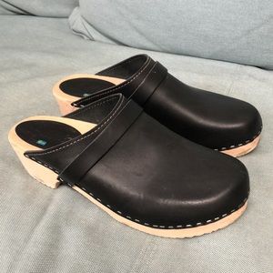 Black leather wooden clogs